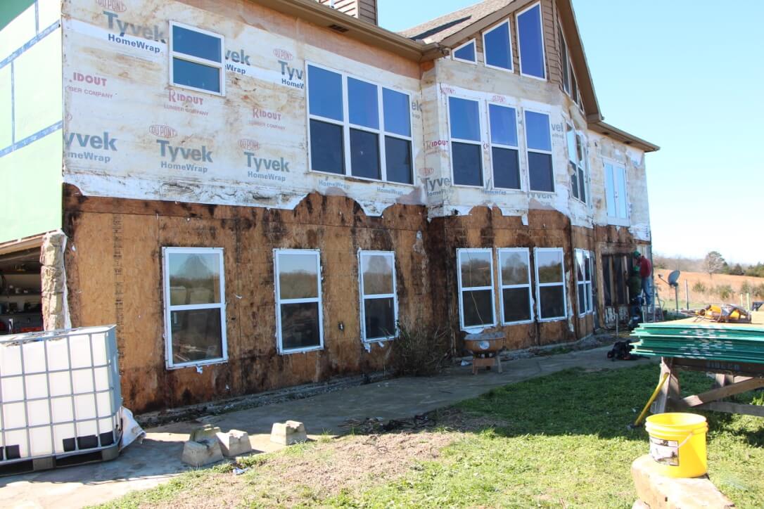 Wood damage on lower portion of house above and below windows